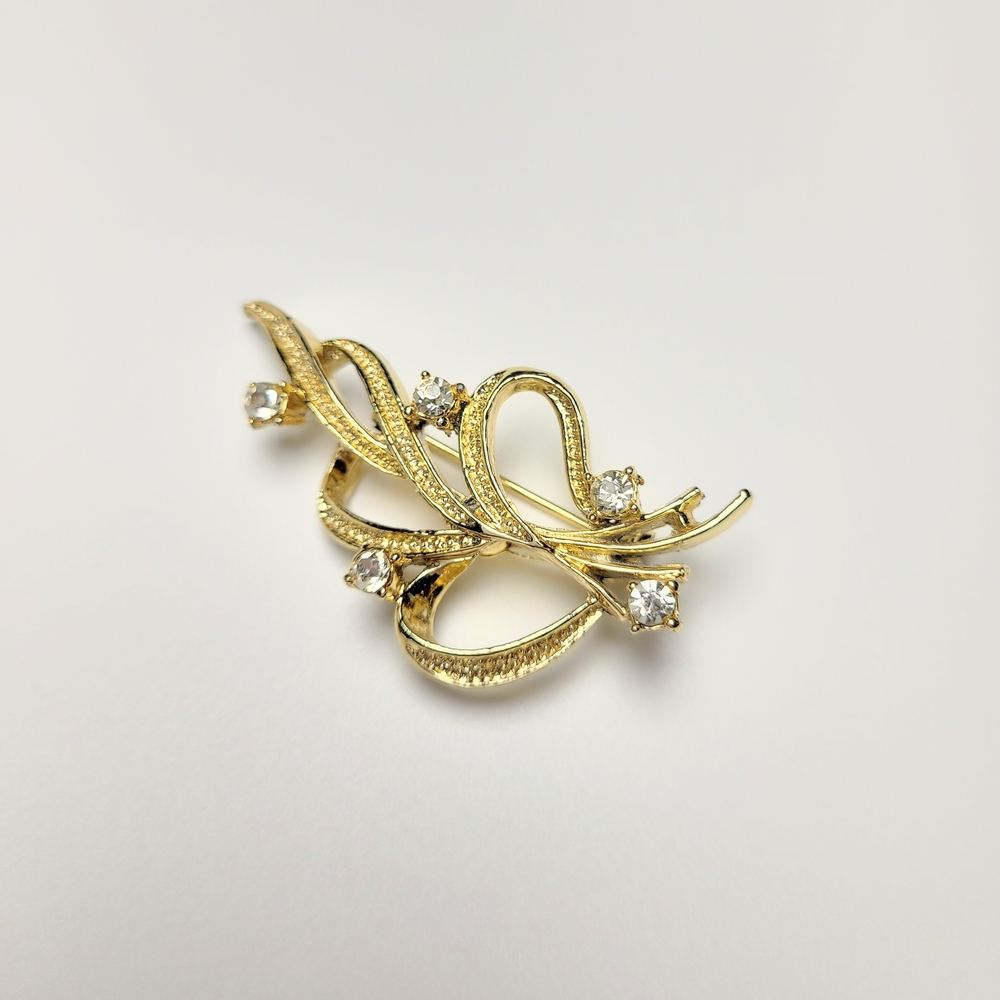 Vintage Gerry’s Gold Tone Rhinestone Swirl Brooch Signed